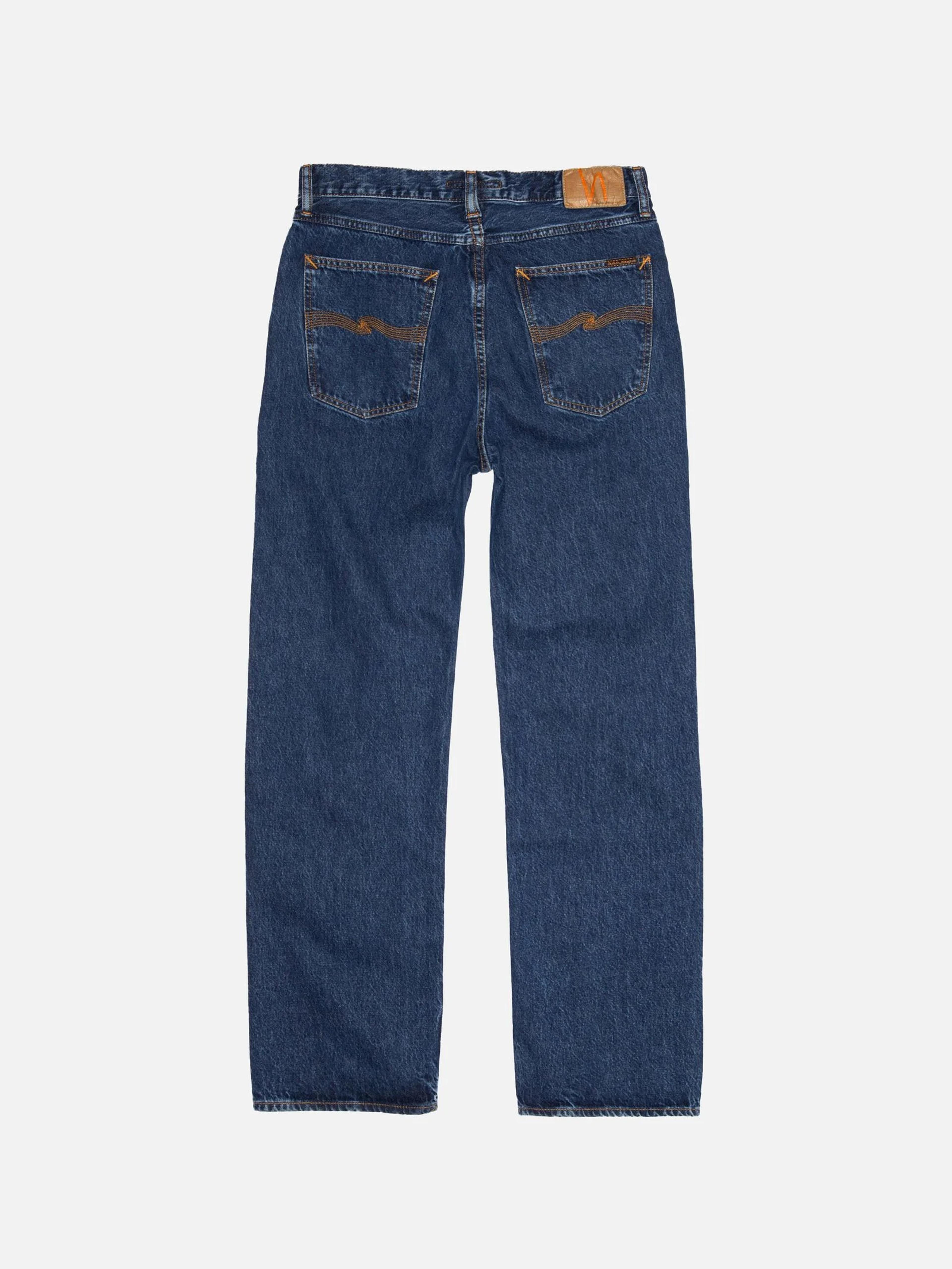 Back view of dark blue jeans with orange stitching on the back pockets and a brown leather waist patch.