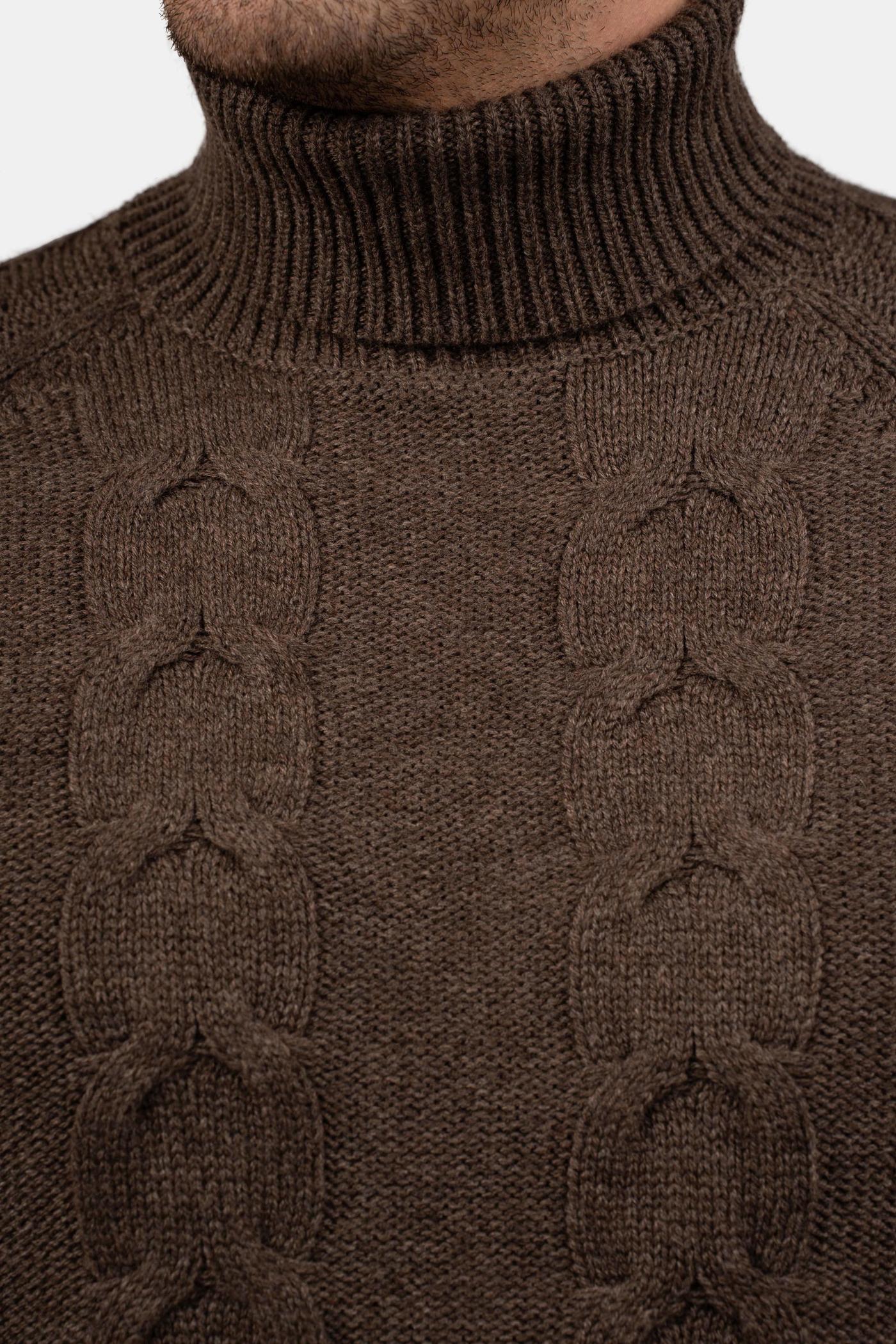 Close-up of a man wearing a brown cable-knit turtleneck sweater.