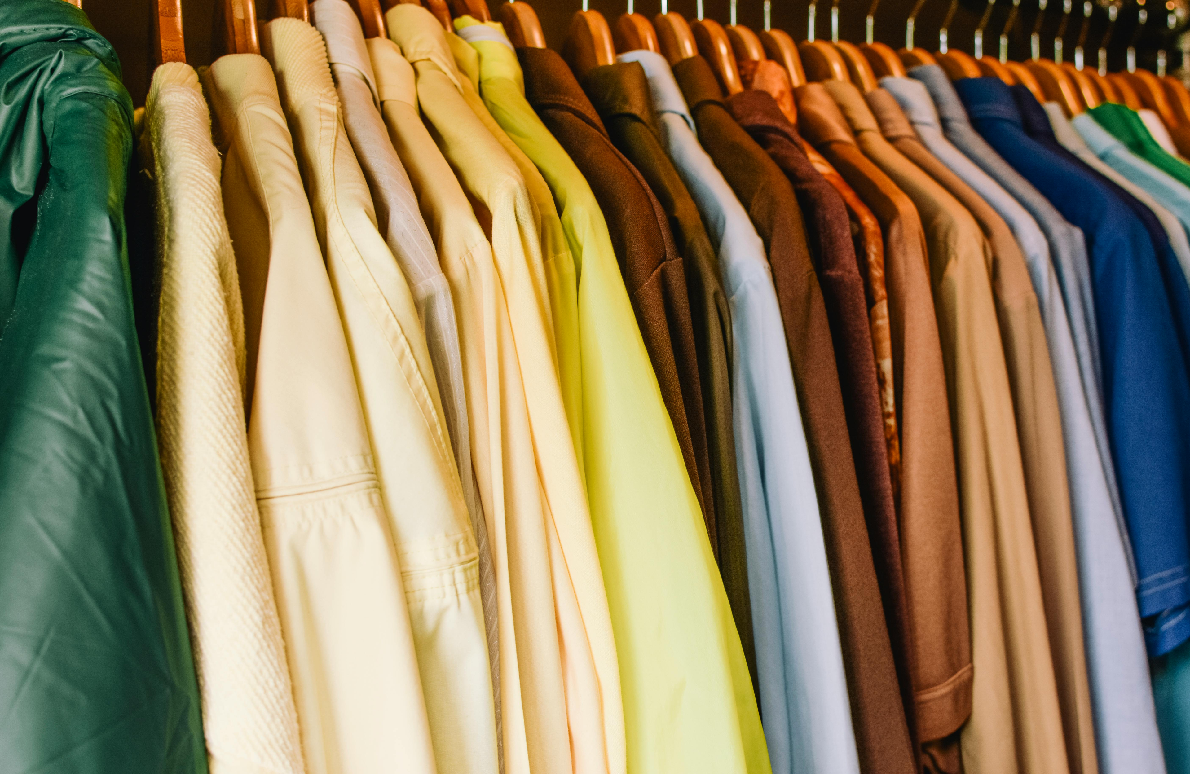 Rack of colorful clothes on hangers.