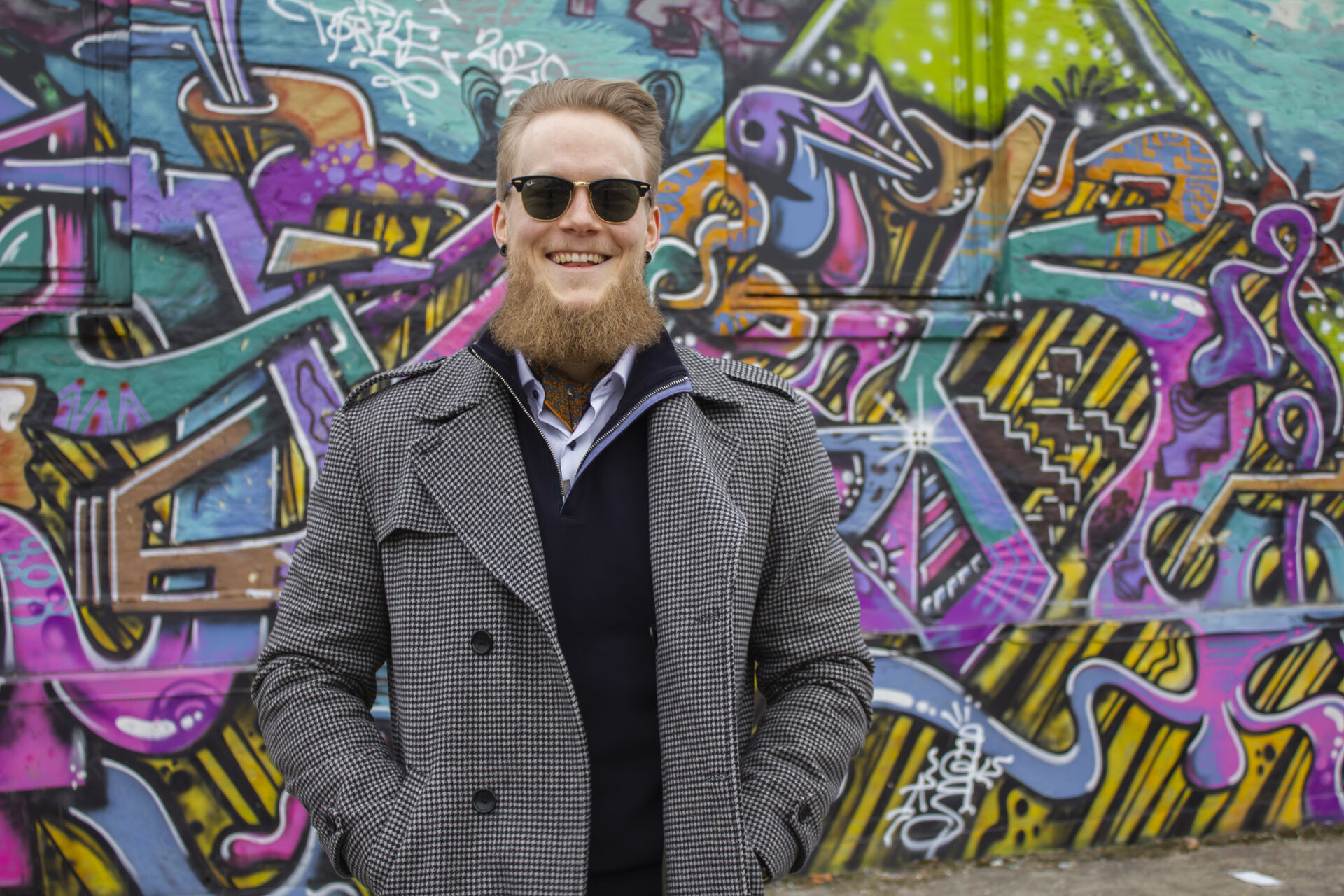 Kristoffer wearing a wool coat, neckerchief and sporting a long beard