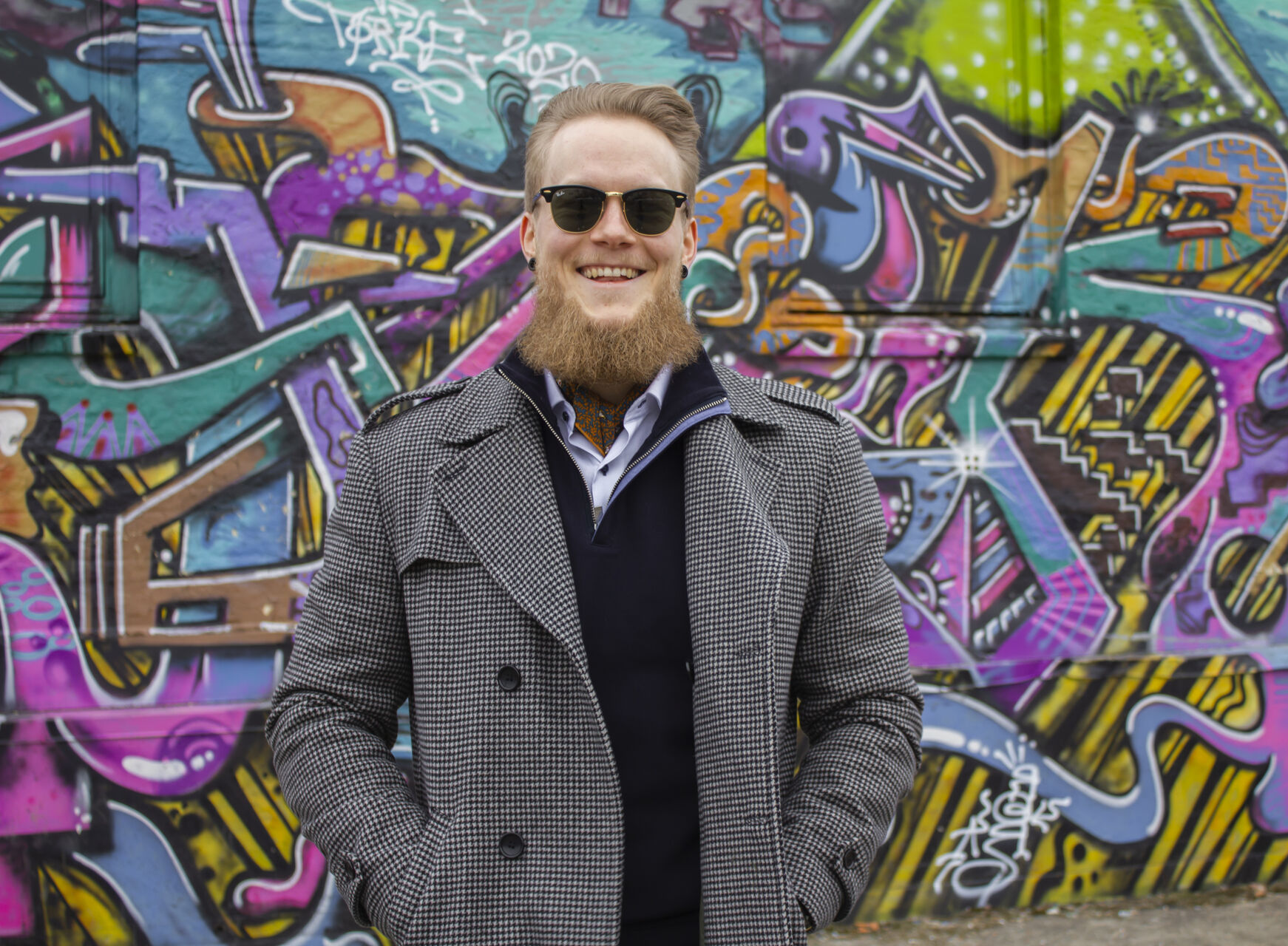 Kristoffer wearing a wool coat, neckerchief and sporting a long beard