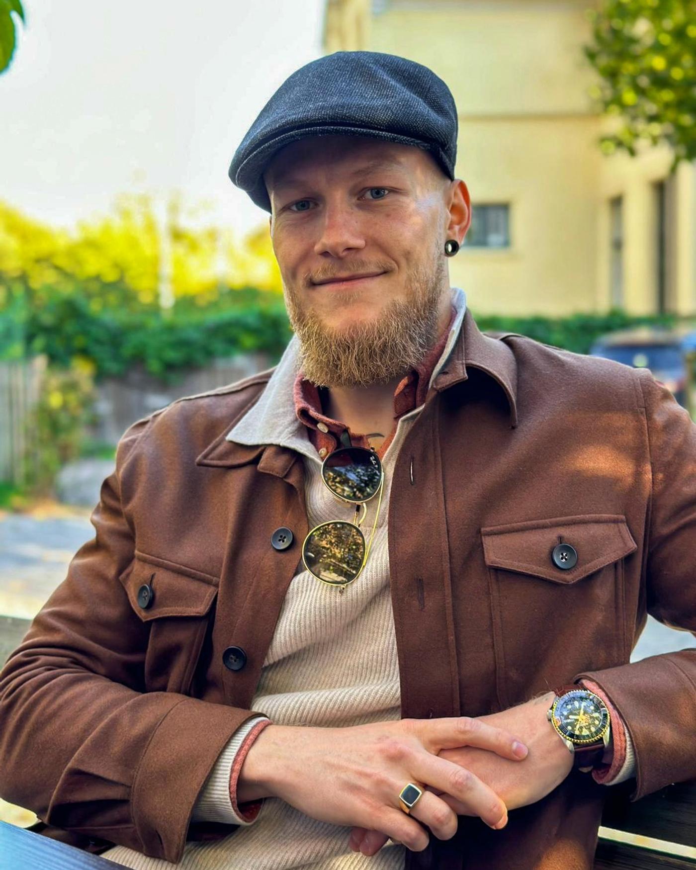 a man with a beard wearing a hat and sunglasses