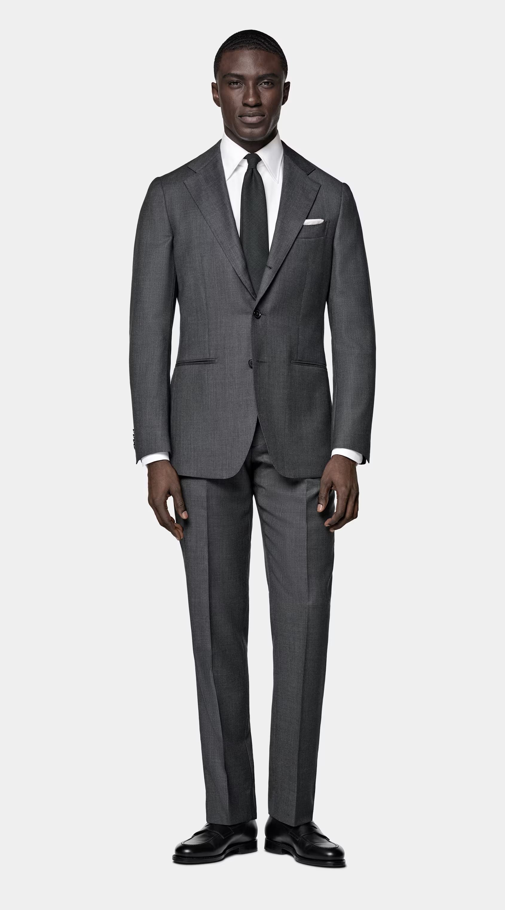 Man in grey suit, white shirt and grey tie