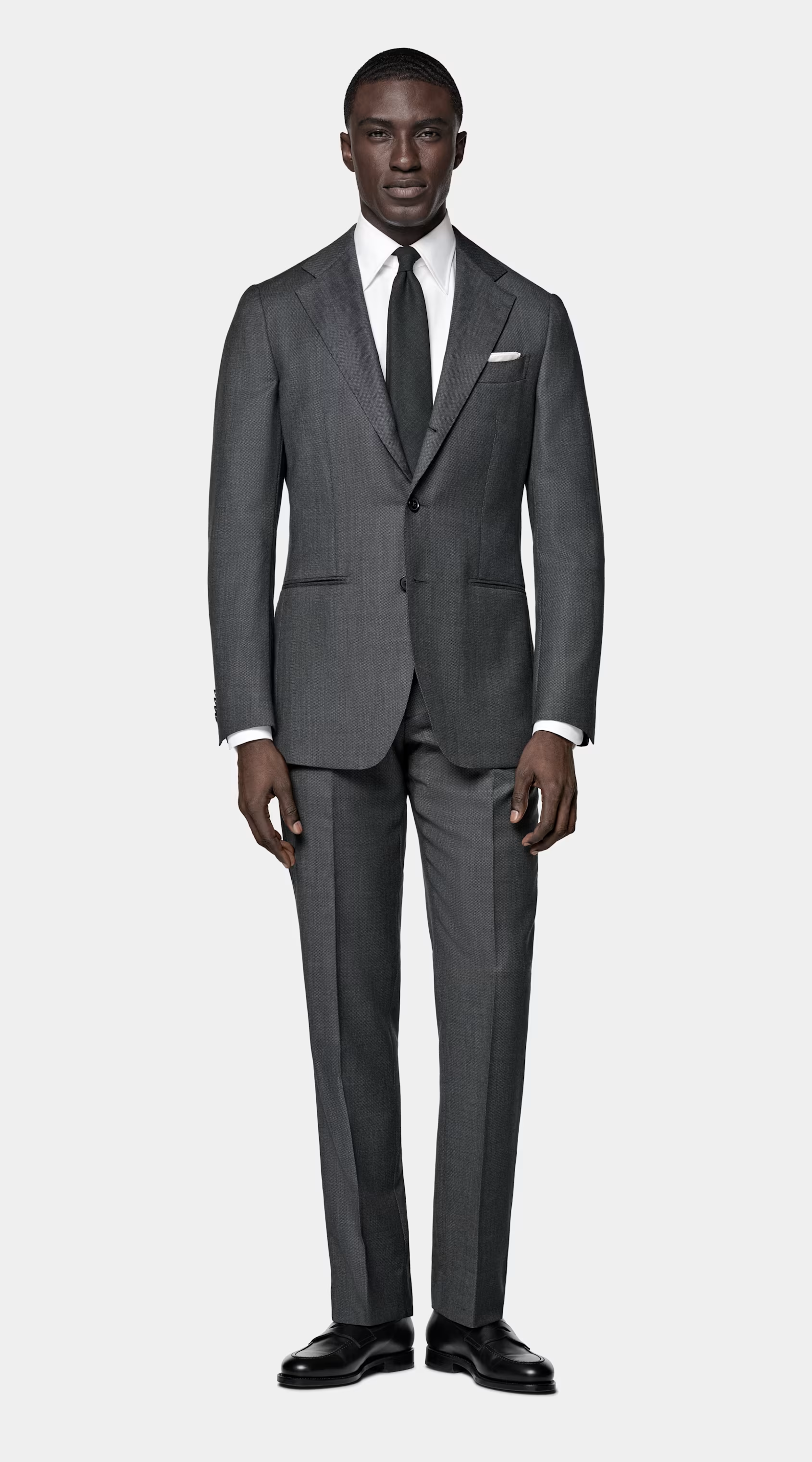 Man in grey suit, white shirt and grey tie