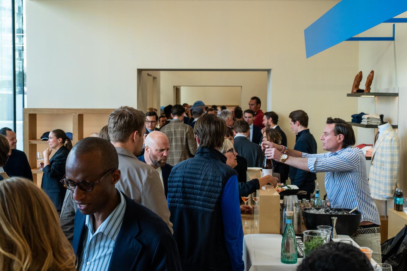 a group of people are mingling in a store