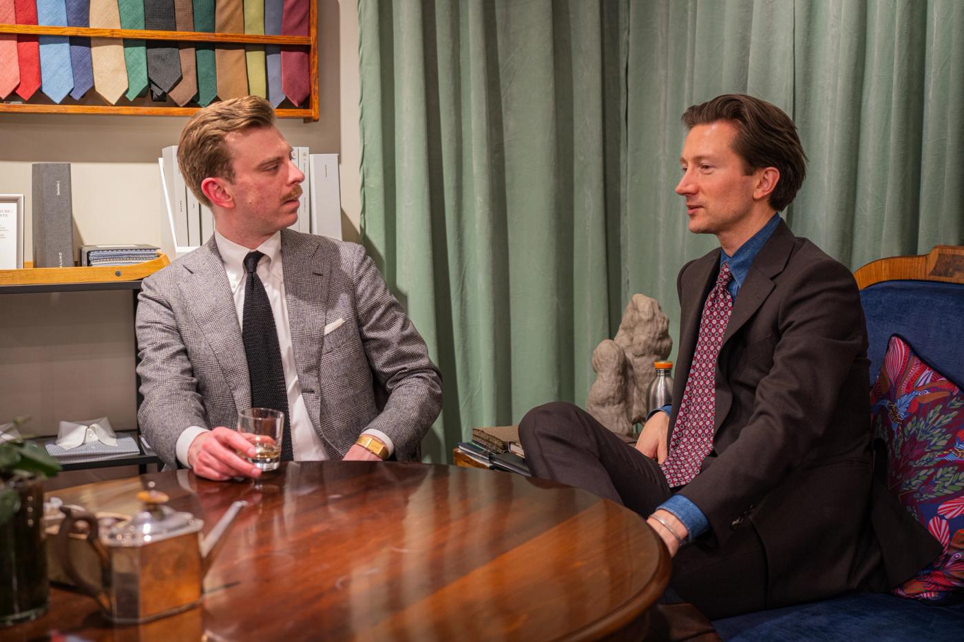 Two men in suits in conversation