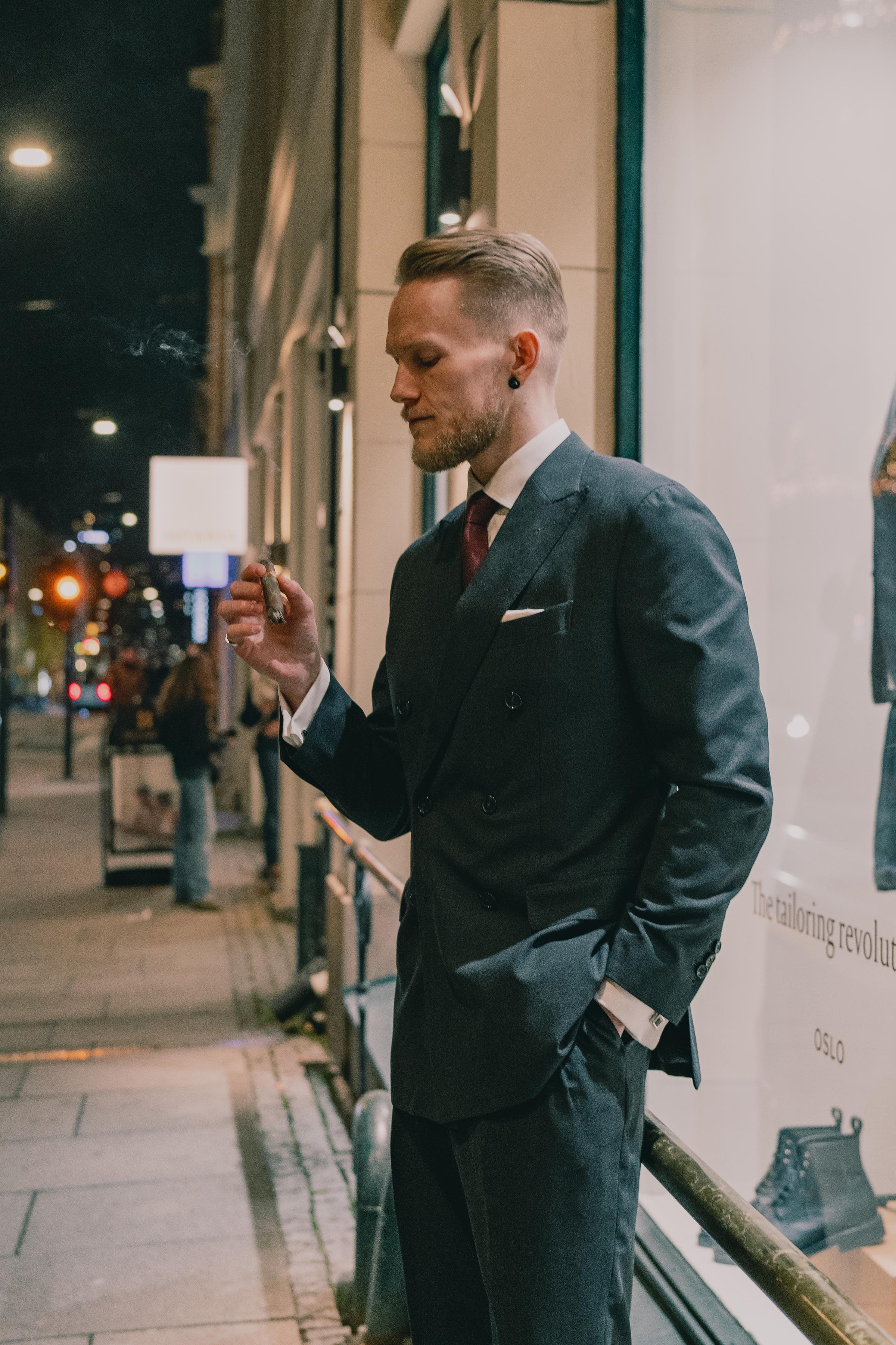 Kristoffer in suit smoking cigar