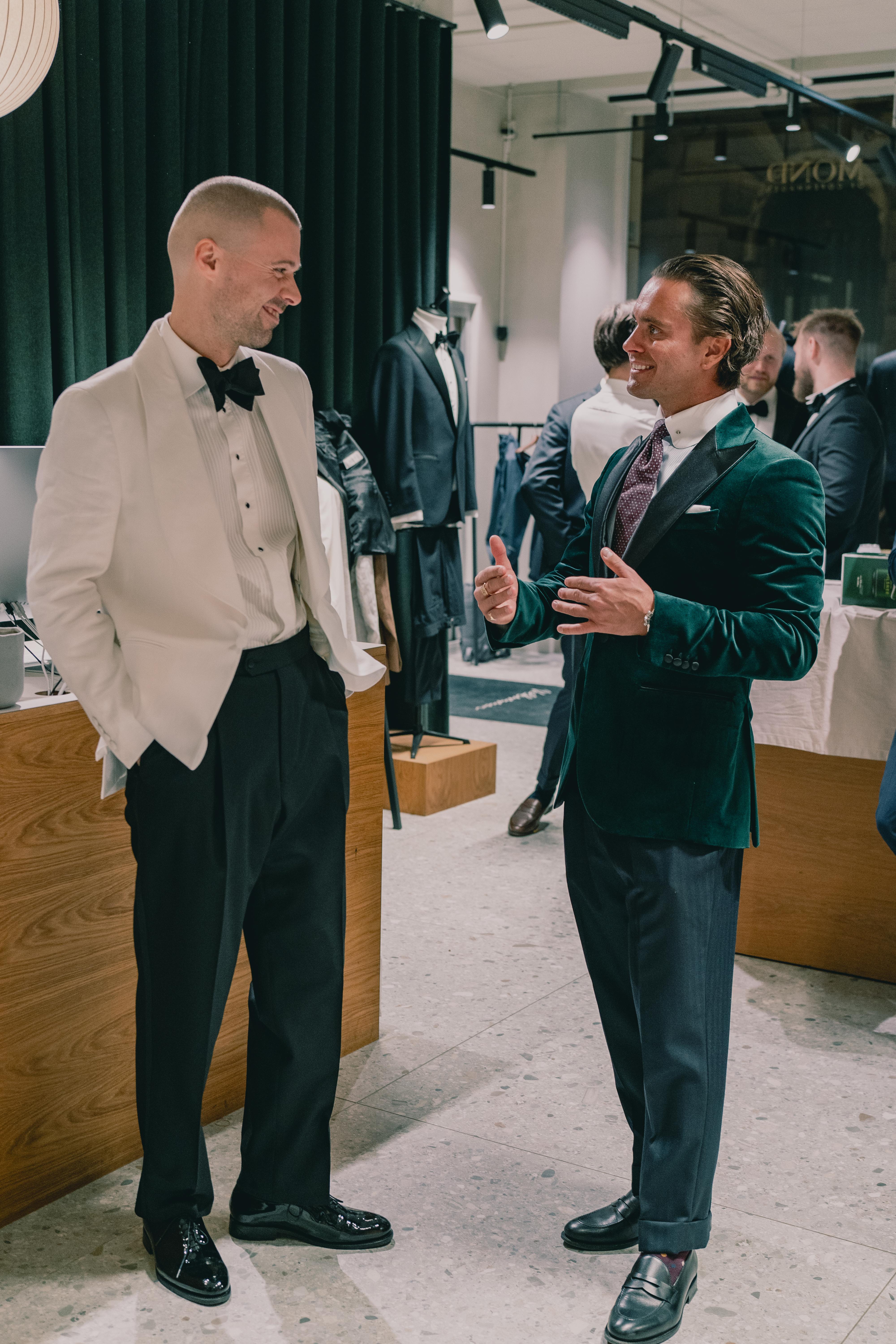 Two well dressed men laughing in conversation