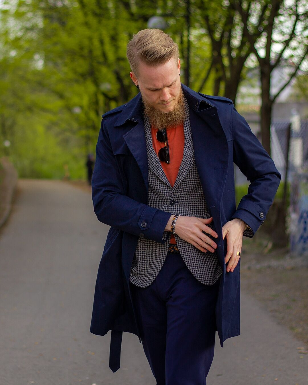 Kristoffer wearing a blazer, trench coat and colorful t-shirt