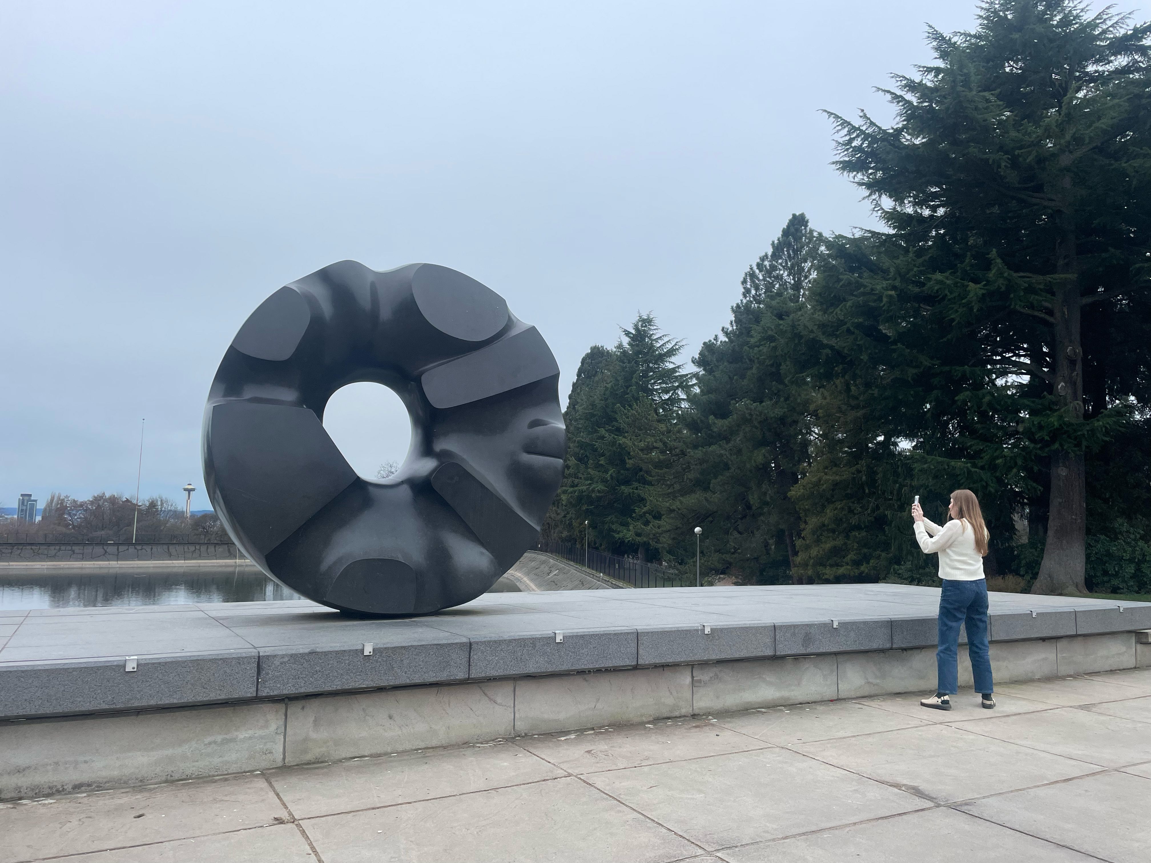 Woman taking photo of art