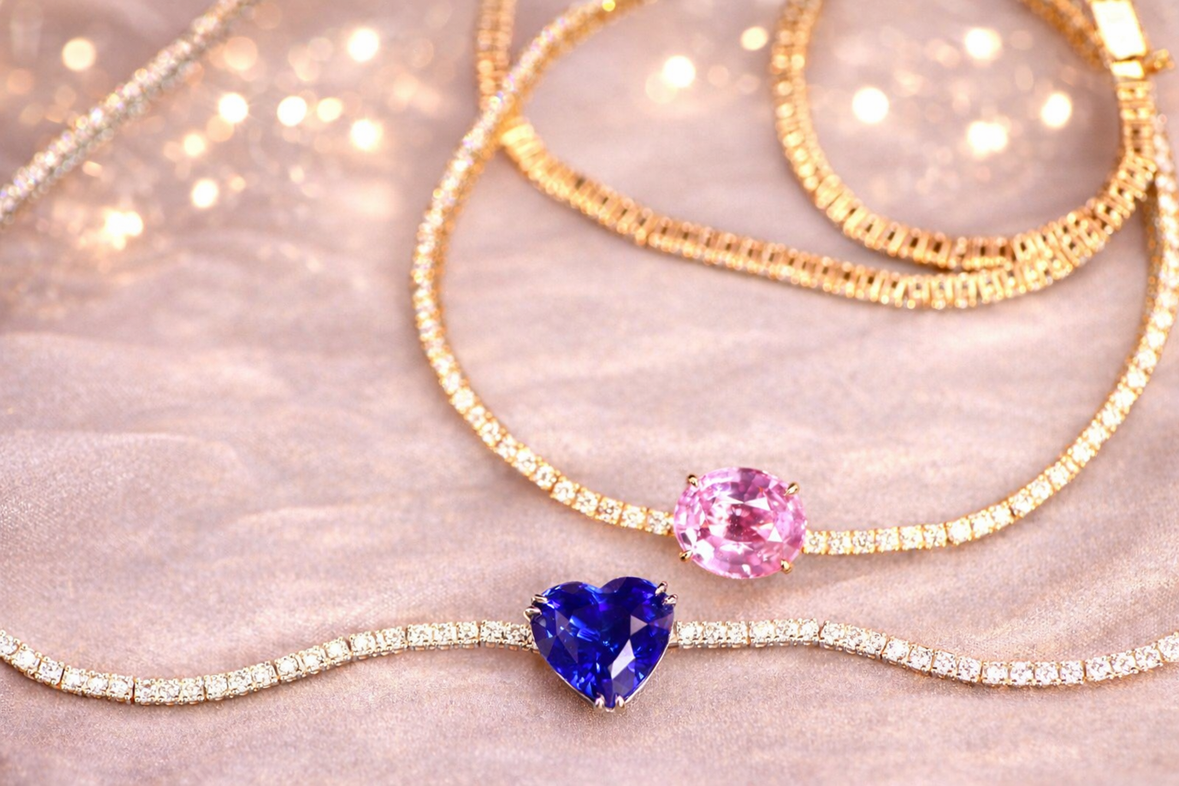 Diamond tennis necklaces, pink and blue sapphire centres