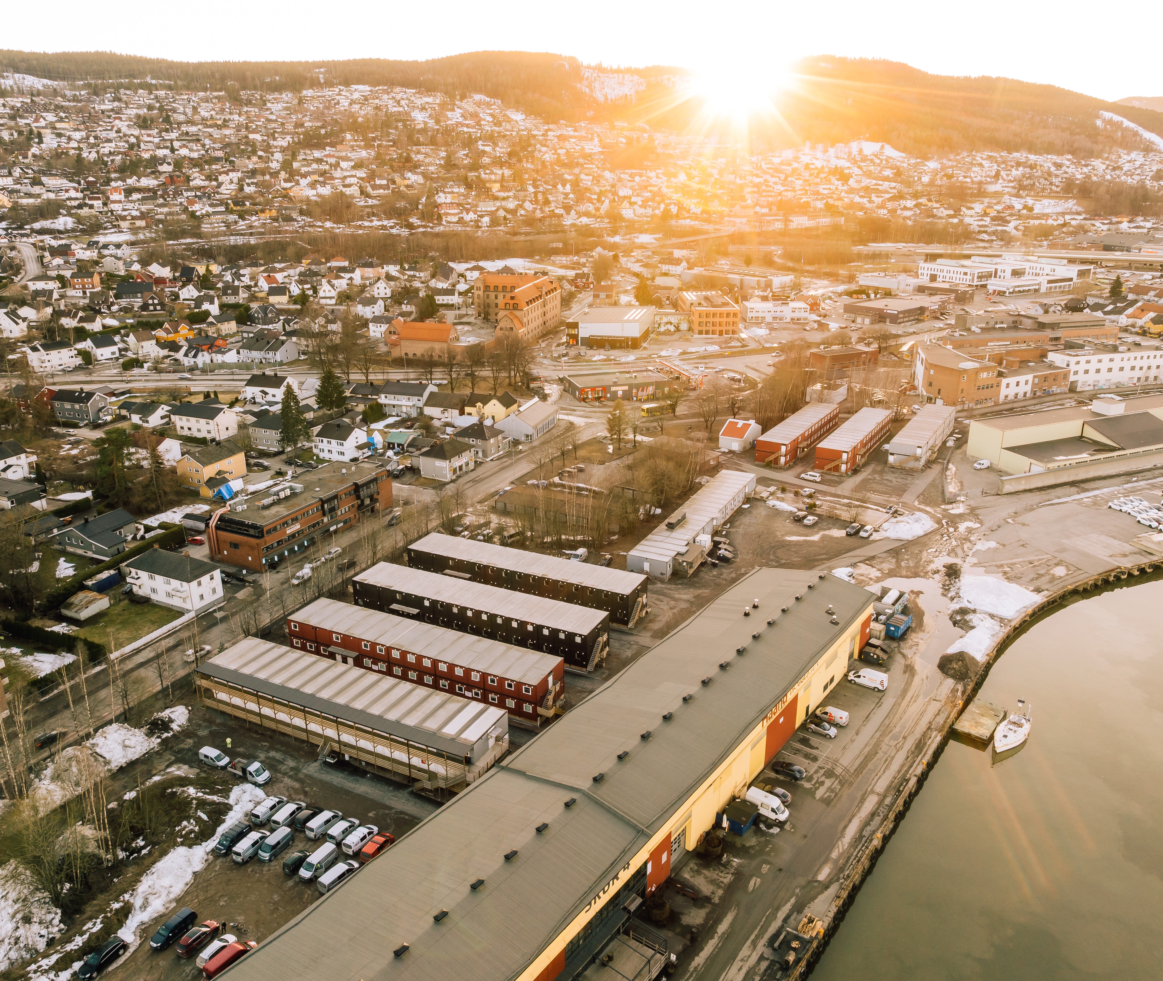 Buildings and a hill with sunrise