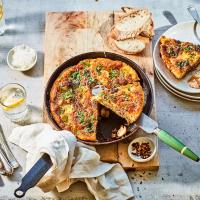 a pan of food with a slice taken out of it on a table . a pan of food with a slice taken out of it on a table .