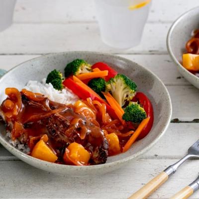Sweet and sour chicken or pork with pineapple over rice, served with broccoli, carrots, and red bell pepper. Sweet and sour chicken or pork with pineapple over rice, served with broccoli, carrots, and red bell pepper.