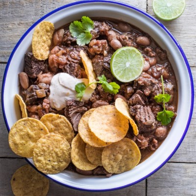 a bowl of chili with tortilla chips and sour cream a bowl of chili with tortilla chips and sour cream
