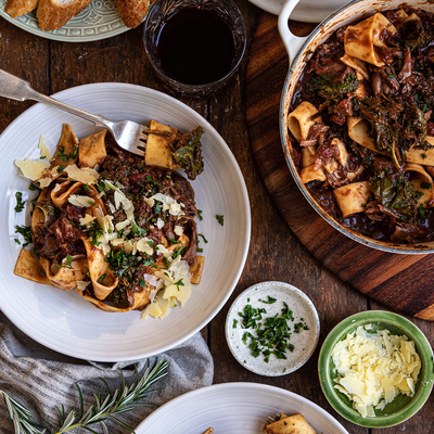 two plates of food with forks and spoons on a table . two plates of food with forks and spoons on a table .