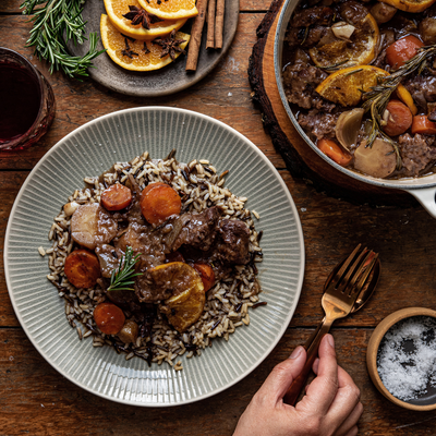 two plates of food with forks and spoons on a table . two plates of food with forks and spoons on a table .