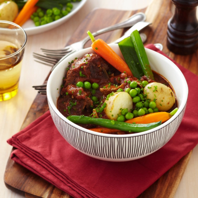 two plates of food with forks and spoons on a table . two plates of food with forks and spoons on a table .