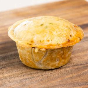 a golden crusted pie sitting on a wooden table 