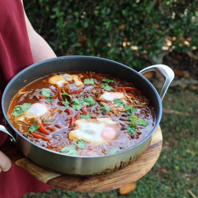 a bowl of soup with noodles and a spoon in it a bowl of soup with noodles and a spoon in it