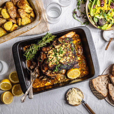 two plates of food with forks and spoons on a table . two plates of food with forks and spoons on a table .
