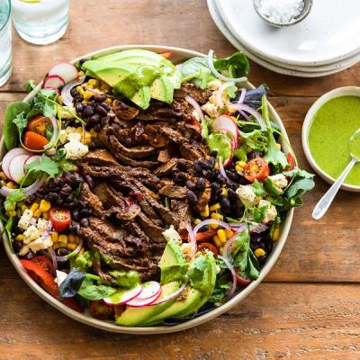 a beef steak salad with avocado, lettuce and black beans a beef steak salad with avocado, lettuce and black beans