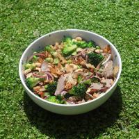 a bowl of food is sitting on top of a lush green field . a bowl of food is sitting on top of a lush green field .