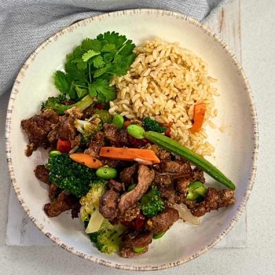 a white plate topped with beef , broccoli , carrots and rice . a white plate topped with beef , broccoli , carrots and rice .