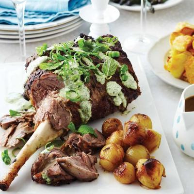 a white plate topped with a large piece of meat and potatoes.
