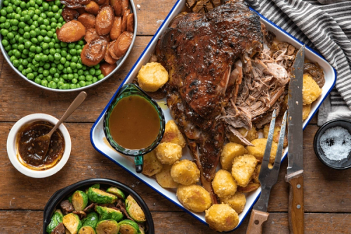 a tray of food including roast beef potatoes and gravy a tray of food including roast beef potatoes and gravy