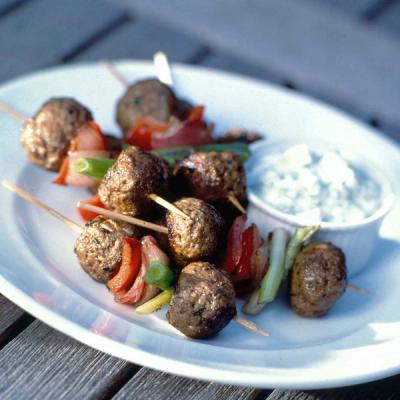 Grilled meatball and vegetable skewers with a creamy dip. Grilled meatball and vegetable skewers with a creamy dip.