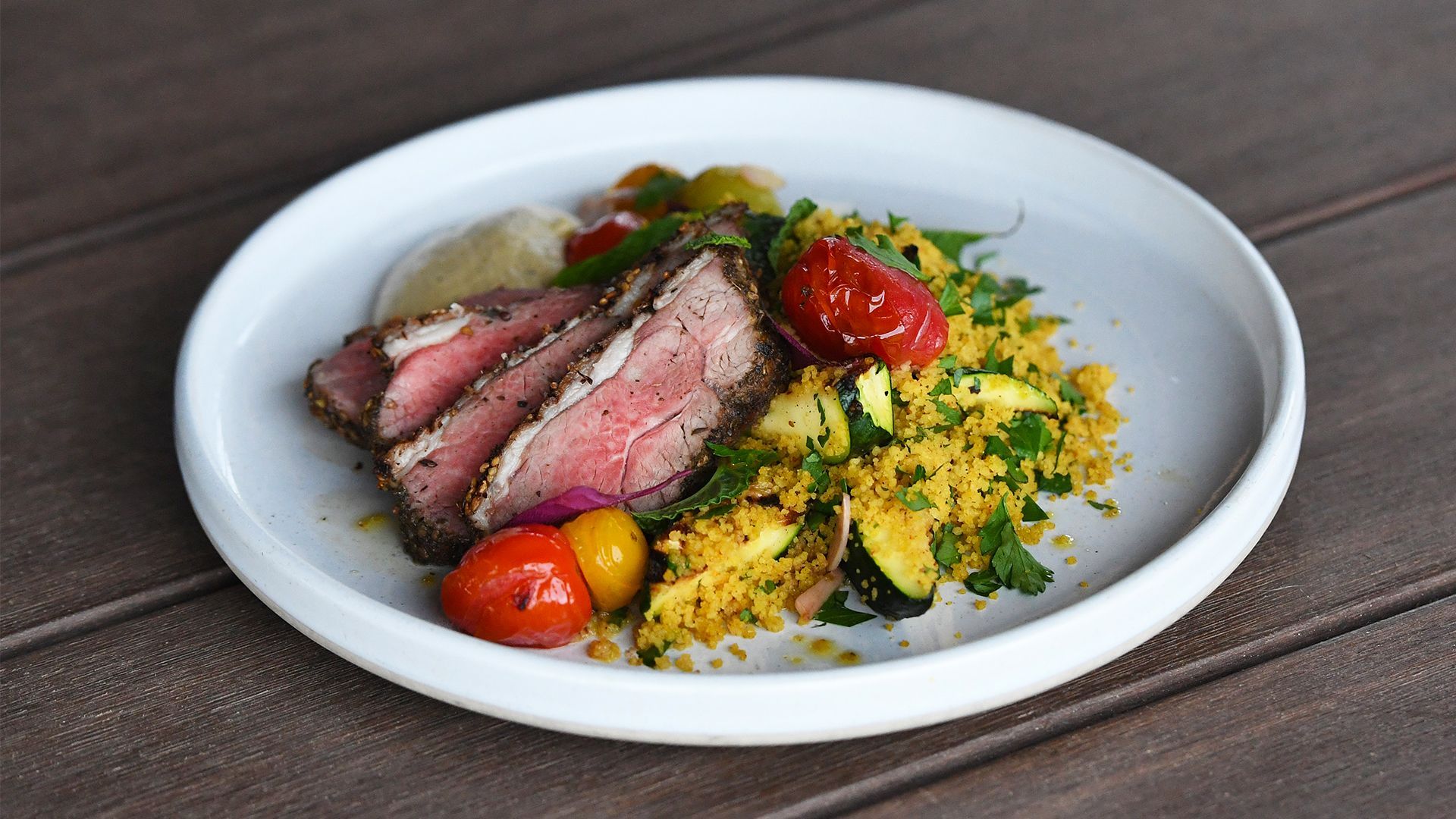 Zaatar crusted lamb rump with couscous, tomato, and a smoky eggplant puree Recipe | Beef + Lamb New 
