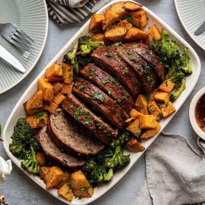 Sliced glazed meatloaf with roasted sweet potatoes and broccoli. Sliced glazed meatloaf with roasted sweet potatoes and broccoli.