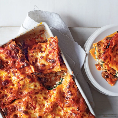 a casserole dish of lasagna with a slice taken out of it a casserole dish of lasagna with a slice taken out of it
