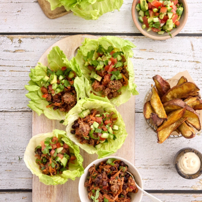 two plates of food with forks and spoons on a table . two plates of food with forks and spoons on a table .