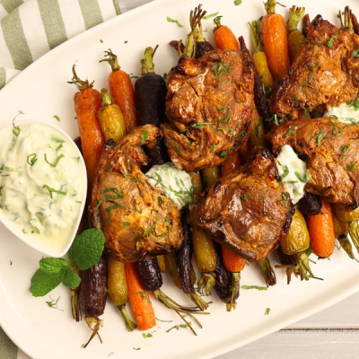 two plates of food with forks and spoons on a table .