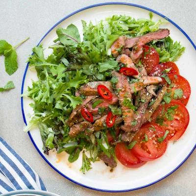 Thai lamb salad with sliced steak, mixed greens, tomatoes, chili, and herbs. Thai lamb salad with sliced steak, mixed greens, tomatoes, chili, and herbs.