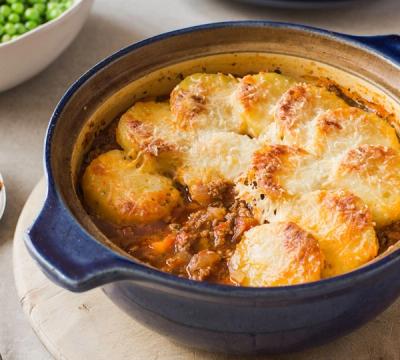 a close up of stuffed eggplant with meat and cheese on a table . a close up of stuffed eggplant with meat and cheese on a table .