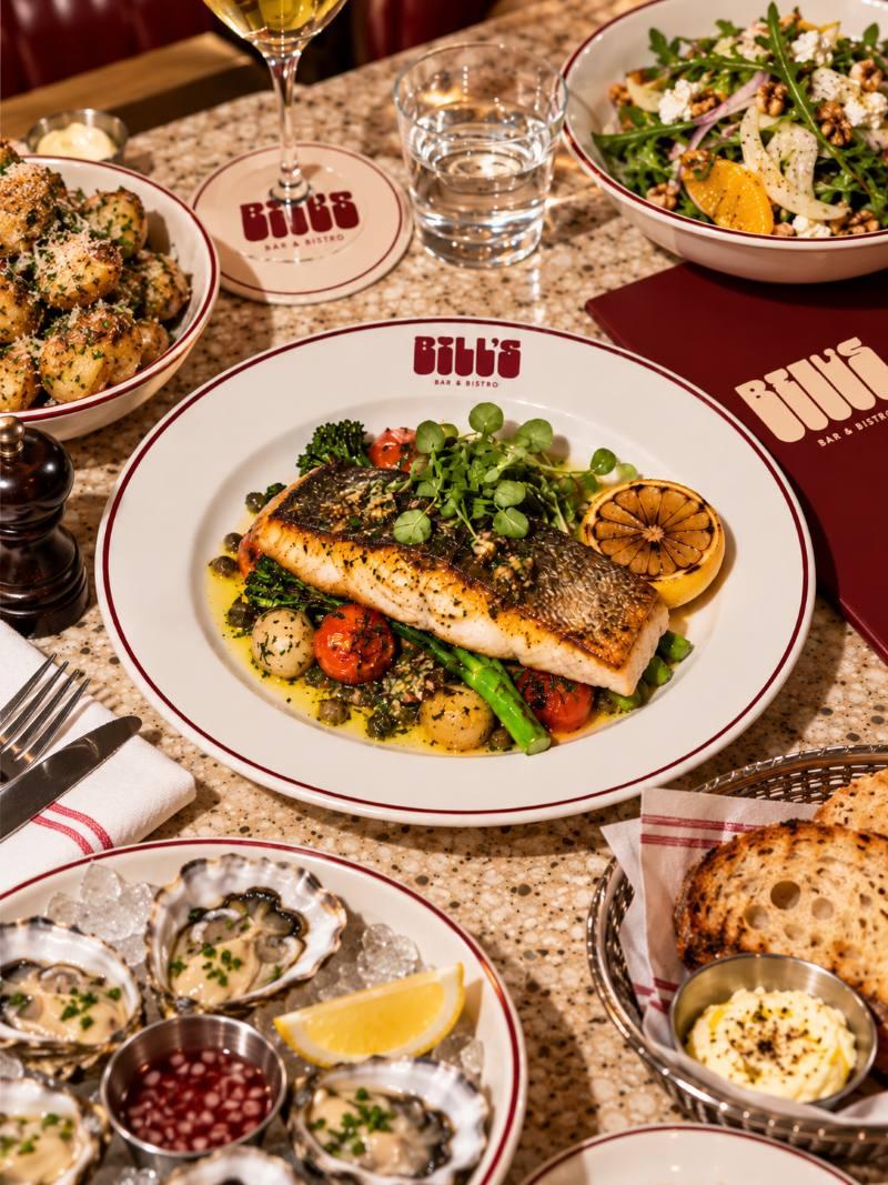 Crispy-skin fish with baby potatoes, broccolini, tomatoes and a chargrilled lemon