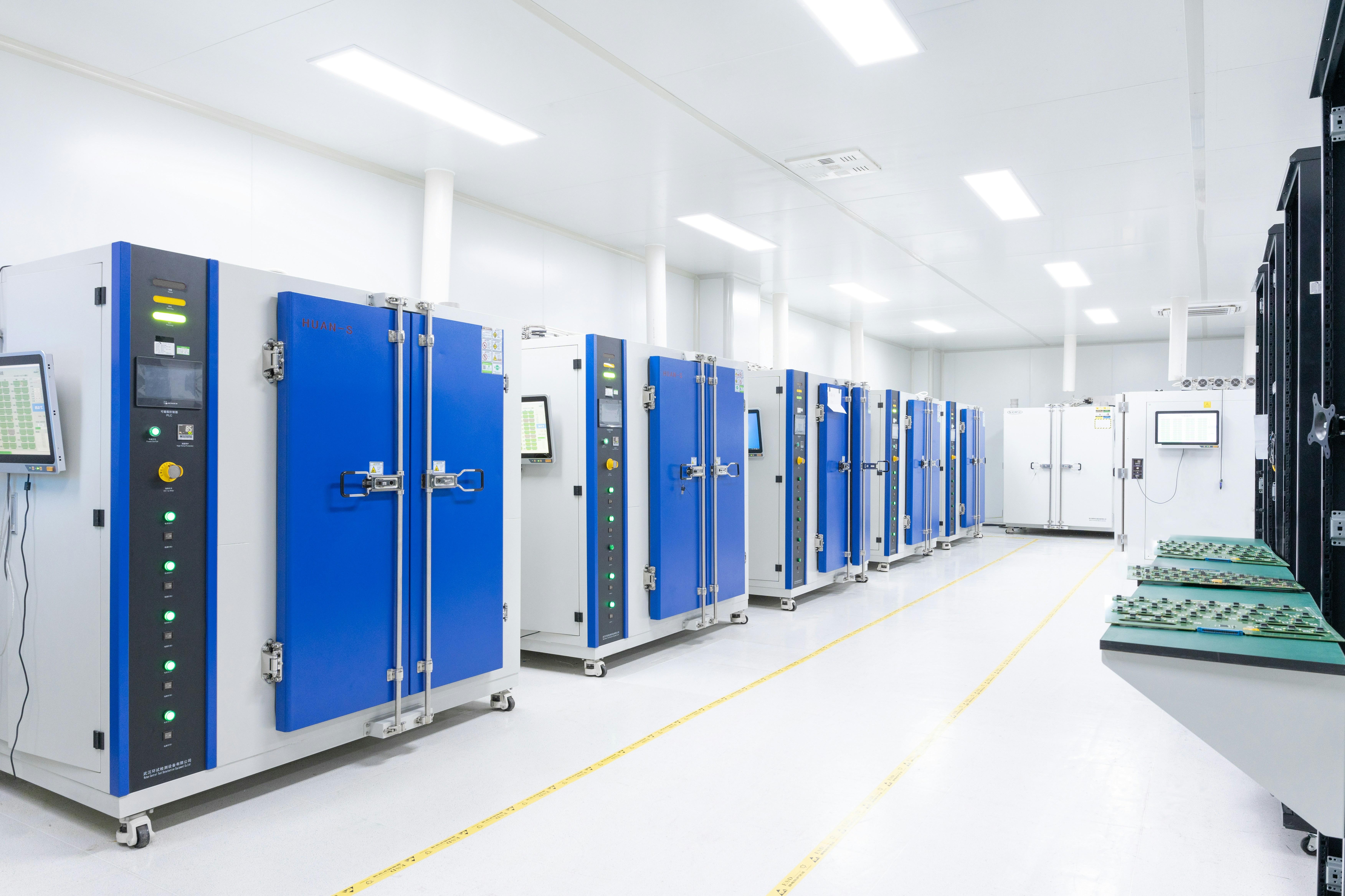 data center white room with white lights and five server units with blue doors