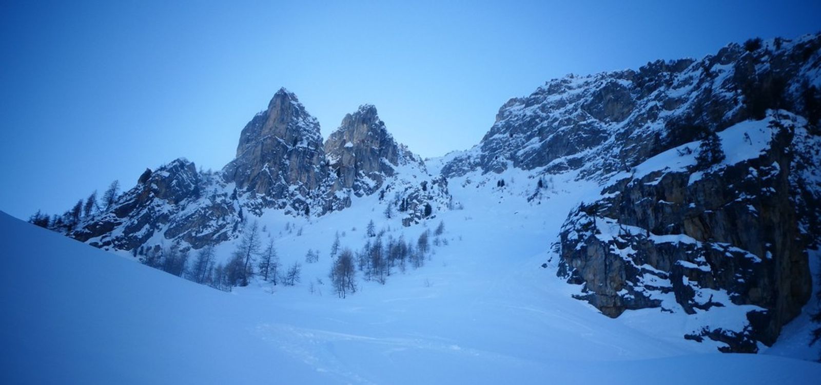 Vue d’ensemble de la ligne enneigée du couloir nord de l’Aiguillas, entre les parois rocheuses.