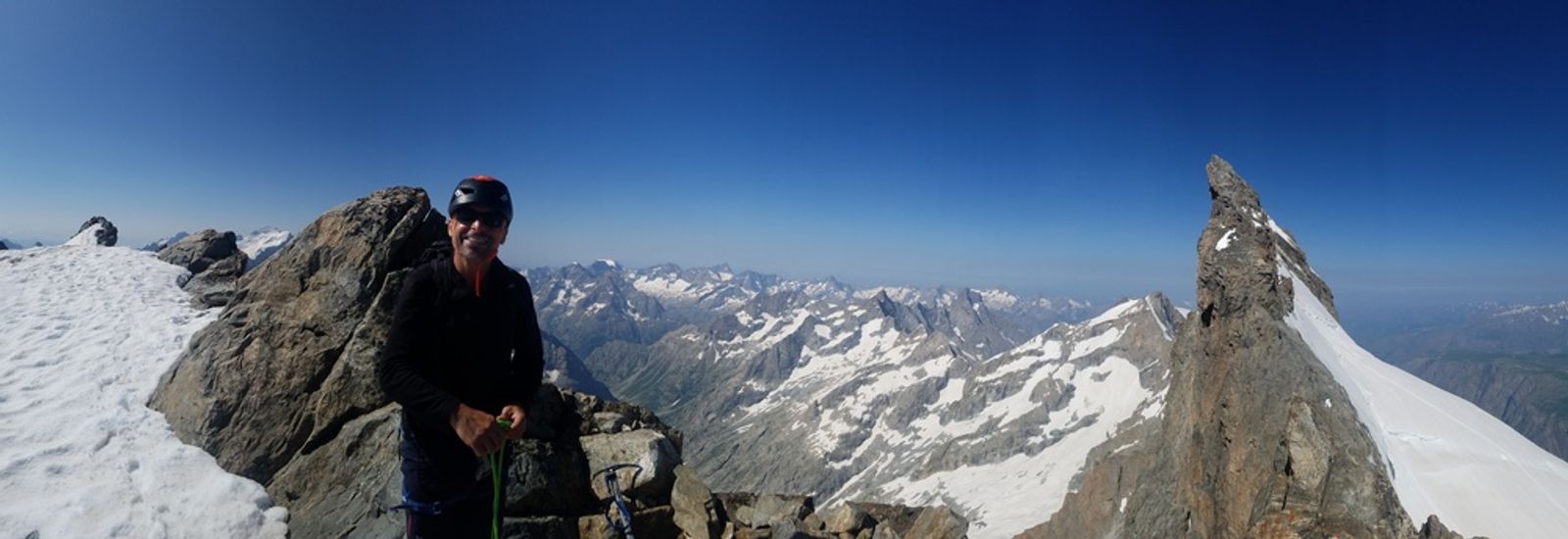 Alain sur l’arête de la Meije Orientale avec le Doigt de Dieu en arrière-plan.