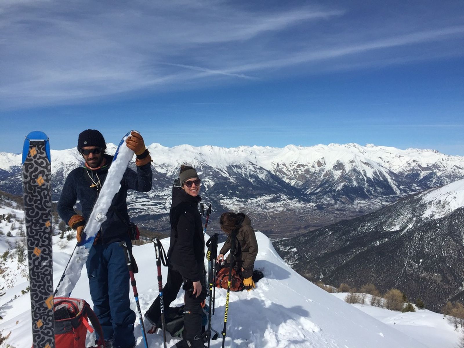 Skiers at the summit removing their climbing skins