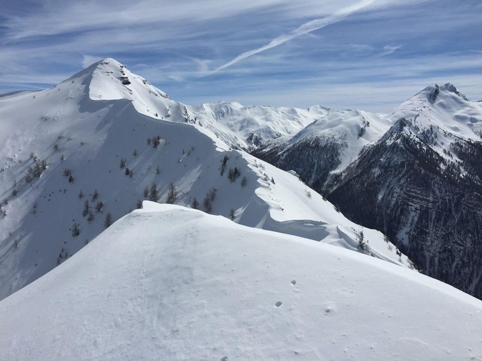 View of a series of snow-capped ridges with cornices