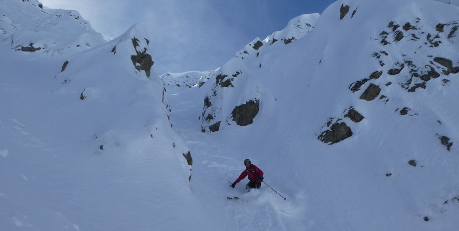 Skier in the narrow part of the couloir