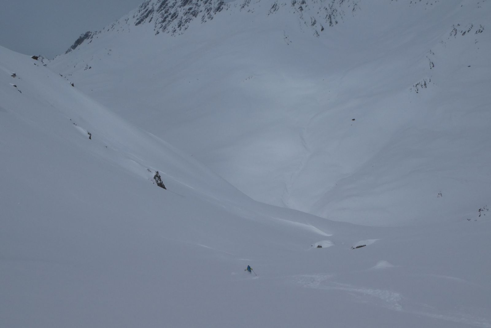 A vast expanse of powder snow is being groomed in the Combe du Vel