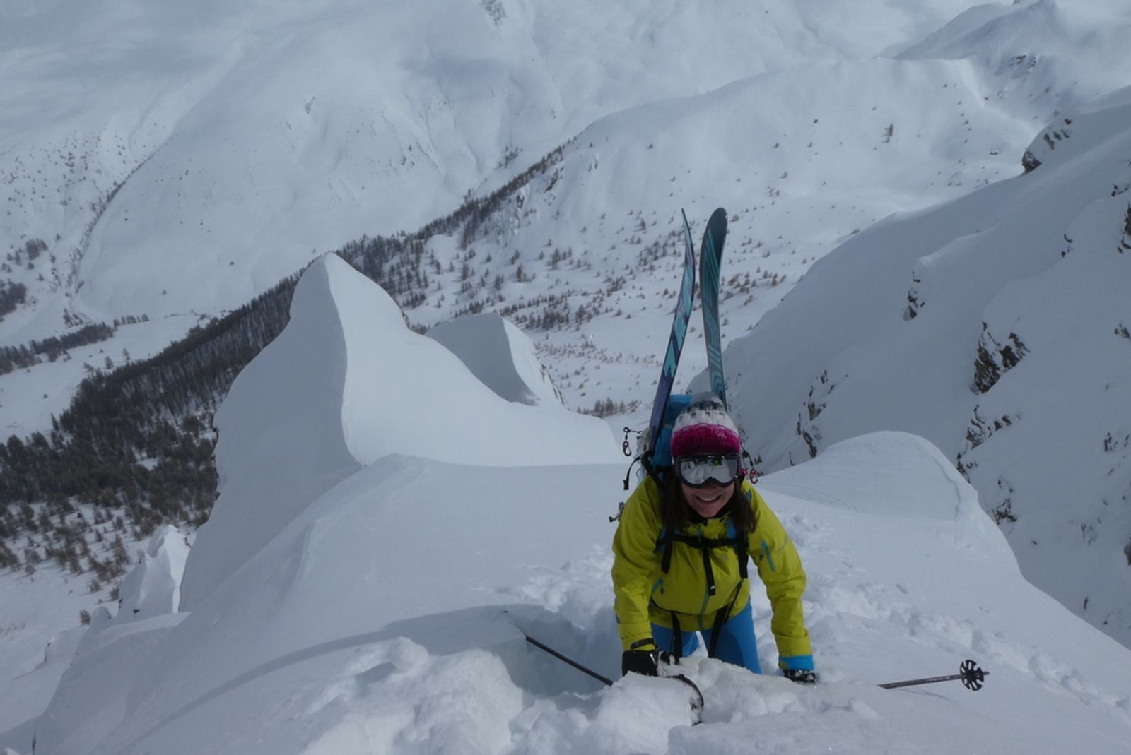 A skier, all smiles, as she crosses the shoulder of the second branch of the Baionnette couloir