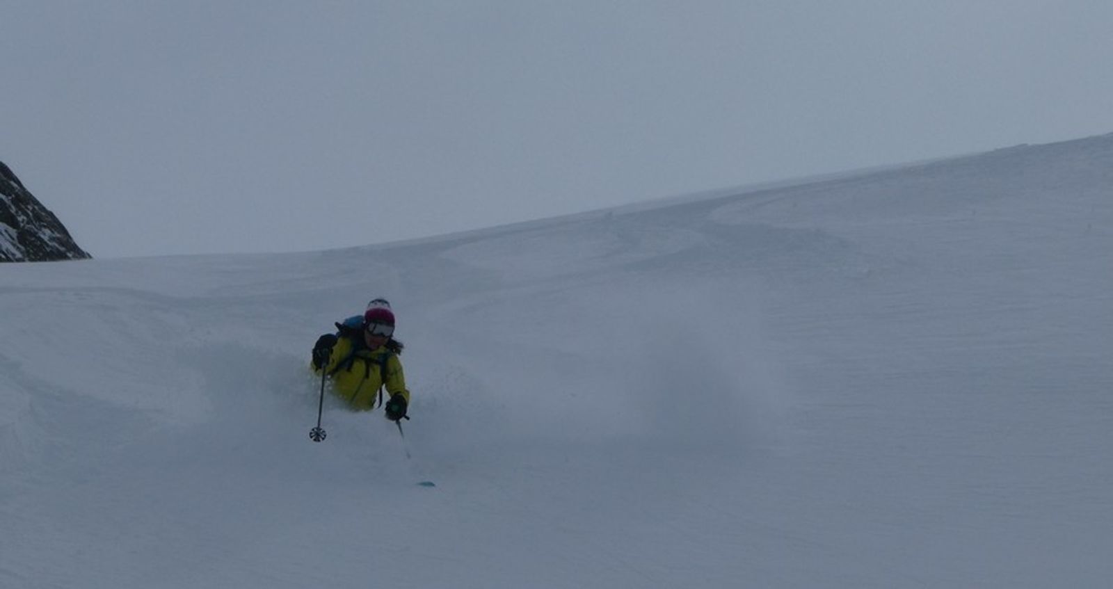 Skier with powder up to her knees