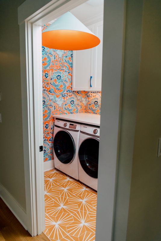 orange laundry room with unique light