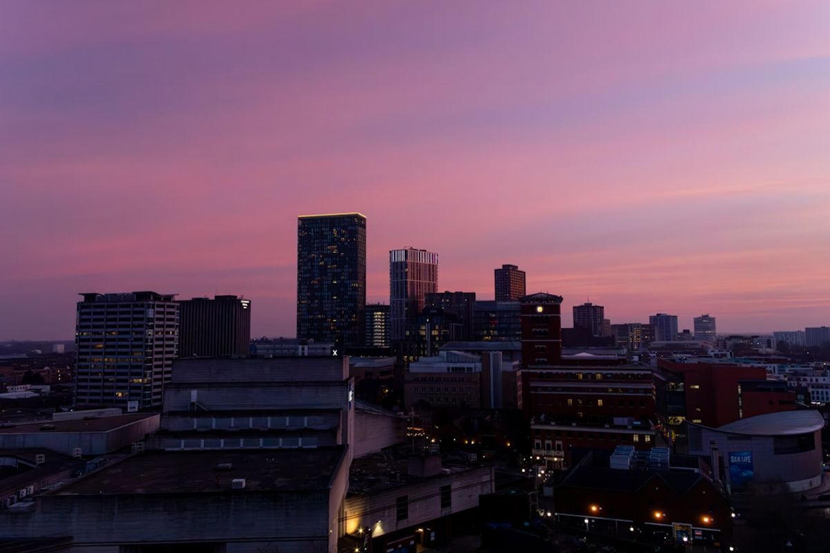 City skyline at dusk with a purple sky